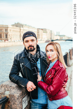 Stylish couple in city hugging and kissing  32445396