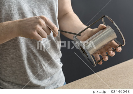 Man with cylindrical metal construction  32446048