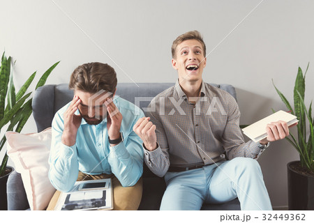 Sad and jolly candidates receiving results of job 32449362