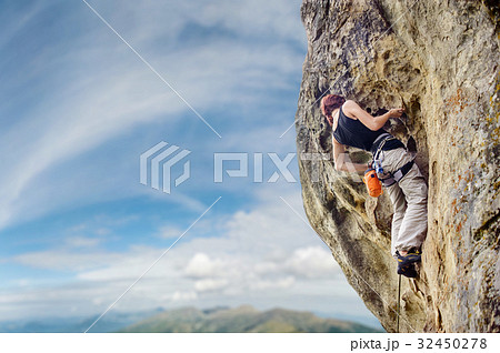 Female rock climber on steep overhanging rock cliff Female rock climber on steep overhanging rock cliff 32450278
