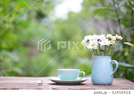 Coffee in blue cup with white flower in blue pot Coffee in blue cup with white flower in blue pot 32450428