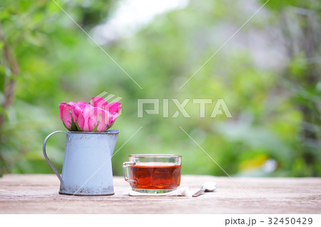 Red tea in glass with blue flower pot 32450429