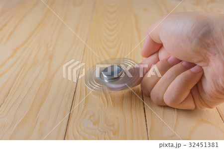 hand with spinner on table. hand with spinner on table. 32451381