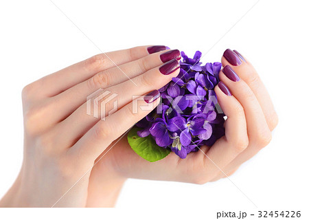 Hands of woman with dark purple manicure on nails 32454226
