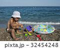 girl plays with toys on the beach 32454248