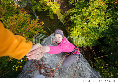 Woman climbing in the nature on large boulder 32454634