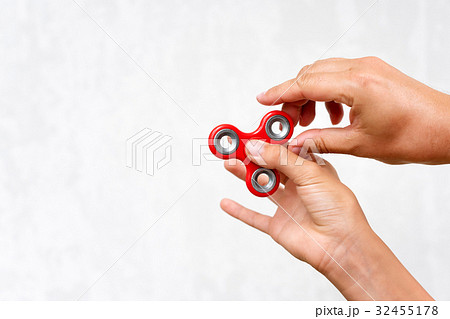 Fidget spinner. Red hand spinner, boys playing Fidget spinner. Red hand spinner, boys playing 32455178