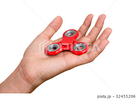 Red hand spinner. Boy playing a popular toy fidget Red hand spinner. Boy playing a popular toy fidget 32455206