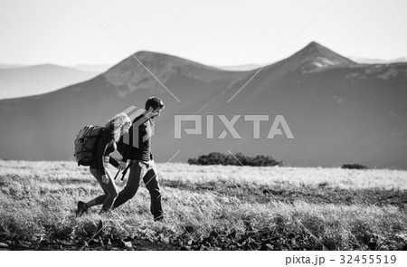 Couple hiking in the beautiful mountains on warm sunny day 32455519