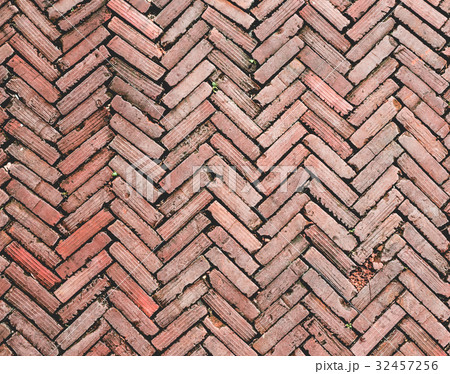 old brick pathway with herringbone pattern 32457256