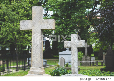 Stone cross gravestones on cemetery - graveyard 32460377