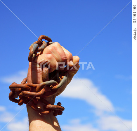 Man's hand is chained in iron chains 32461466
