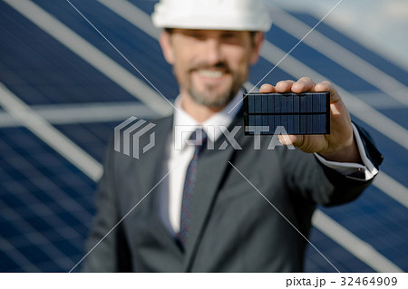 Close up view on photovoltaic element in hand of Close up view on photovoltaic element in hand of 32464909