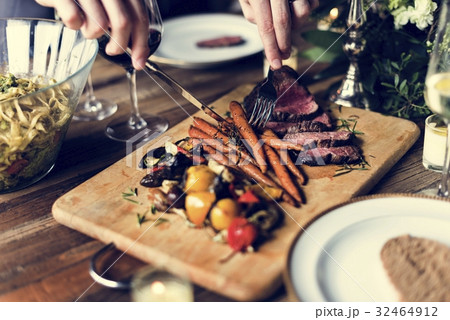 Hands Holding Knife and Fork Getting Food From Dish 32464912