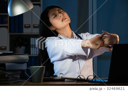 Photo of a tired young female doctor stretch Photo of a tired young female doctor stretch 32469621