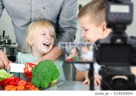 man with children filming the meal preparation 32469904