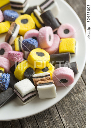 Mixed liquorice candies on plate. 32473003