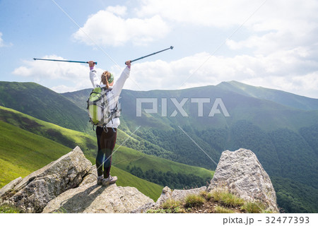 Young woman hiking in the mountains Young woman hiking in the mountains 32477393