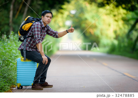 Backpacker is hitchhiking. 32478885