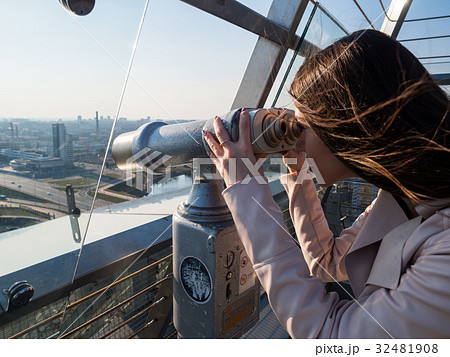 Tourist look observant binoculars telescope on panoramic view Tourist look observant binoculars telescope on panoramic view 32481908