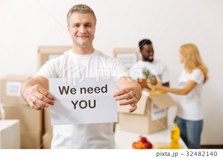 Handsome nice guy encouraging volunteering 32482140