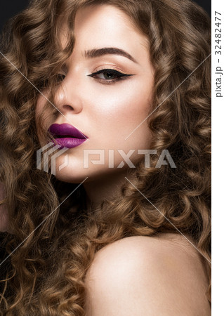 Beautiful brunette girl with a perfectly curly Beautiful brunette girl with a perfectly curly 32482477
