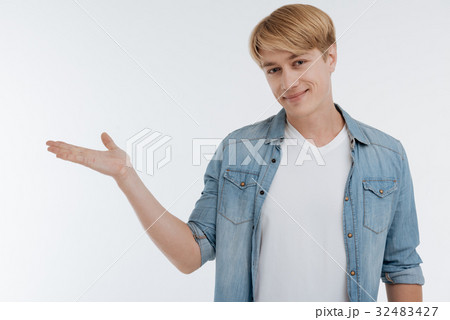 Positive male person putting hand as if Positive male person putting hand as if 32483427