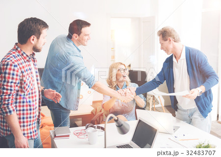 Cheerful colleagues making a bet 32483707