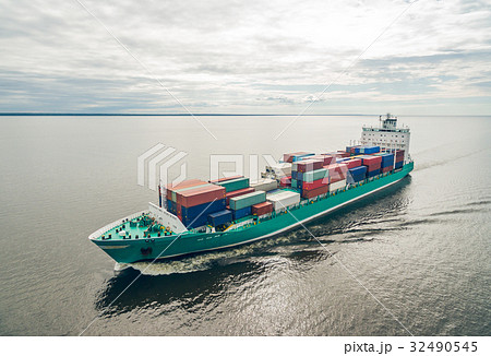Aerial view of container ship sailing in sea Aerial view of container ship sailing in sea 32490545