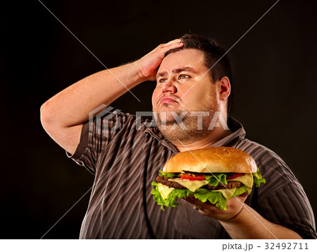 Fat man eating fast food hamberger. Breakfast for Fat man eating fast food hamberger. Breakfast for 32492711