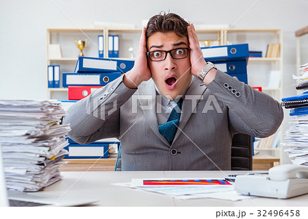 Businessman busy with much paperwork Businessman busy with much paperwork 32496458