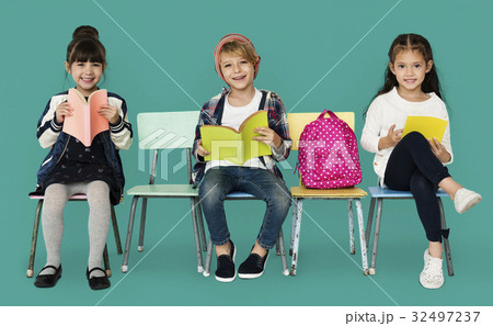 Happiness group of cute and adorable students reading book Happiness group of cute and adorable students reading book 32497237