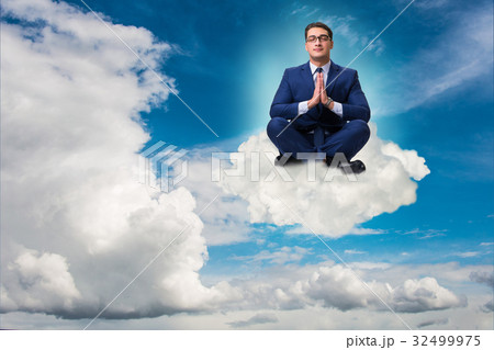 Businessman meditating in the sky Businessman meditating in the sky 32499975