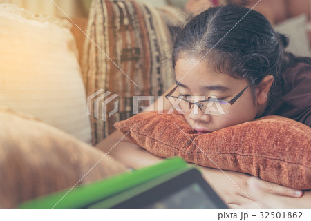 Asian cute girl looking on screen of tablet Asian cute girl looking on screen of tablet 32501862