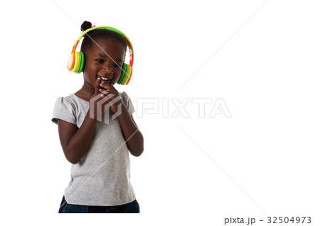 African happy little girl with headphones.Isolated African happy little girl with headphones.Isolated 32504973