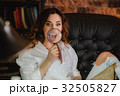 funny woman smiling and show teeth through a 32505827