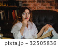 funny woman looking through a magnifying glass 32505836
