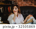 funny woman looking through a magnifying glass 32505869