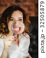funny woman smiling and show teeth through a 32505879