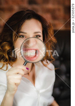 funny woman smiling and show teeth through a funny woman smiling and show teeth through a 32505879