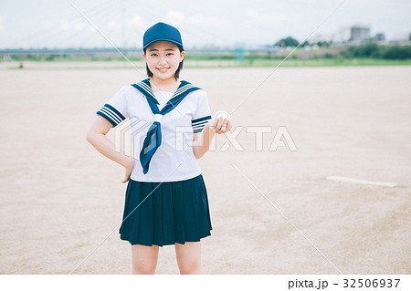野球ボールとマネージャーの女子高生の写真素材