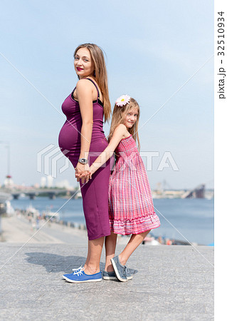 Happy family, pregnant mother and her daughter 32510934