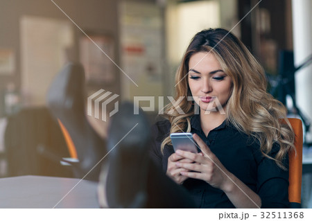 Typing business message. Confident young woman in Typing business message. Confident young woman in 32511368