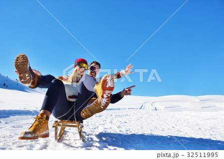 Young Couple Sledding And Enjoying On Sunny Winter Young Couple Sledding And Enjoying On Sunny Winter 32511995