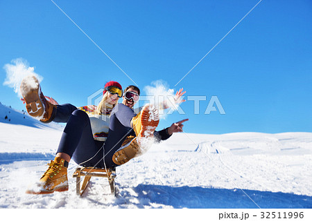Young Couple Sledding And Enjoying On Sunny Winter 32511996