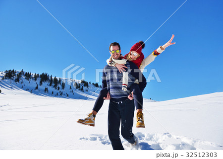 Loving couple playing together in snow outdoor. 32512303