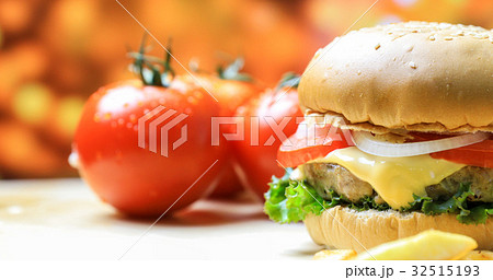 Burger on wooden plate with french fries Burger on wooden plate with french fries 32515193
