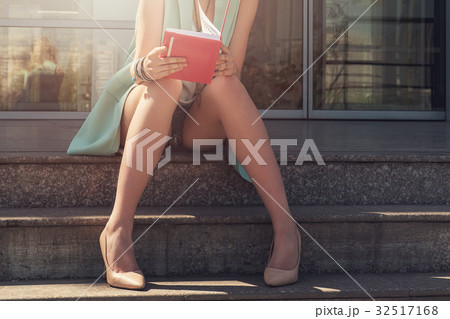 woman with beauty leg holding a book 32517168