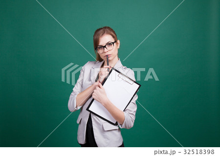 teacher with papers in green boards teacher with papers in green boards 32518398