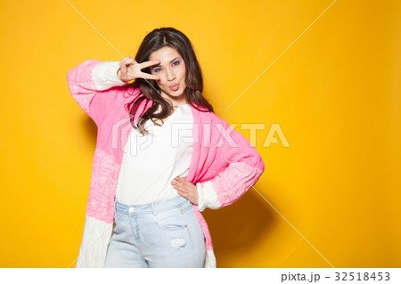 the girl in the pink jacket shows two fingers the girl in the pink jacket shows two fingers 32518453